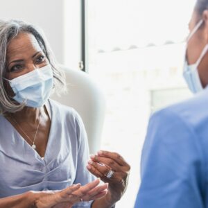 Senior woman talks with female healthcare professional