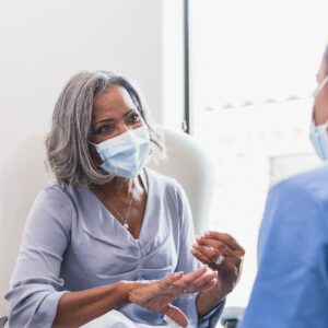Senior woman talks with female healthcare professional